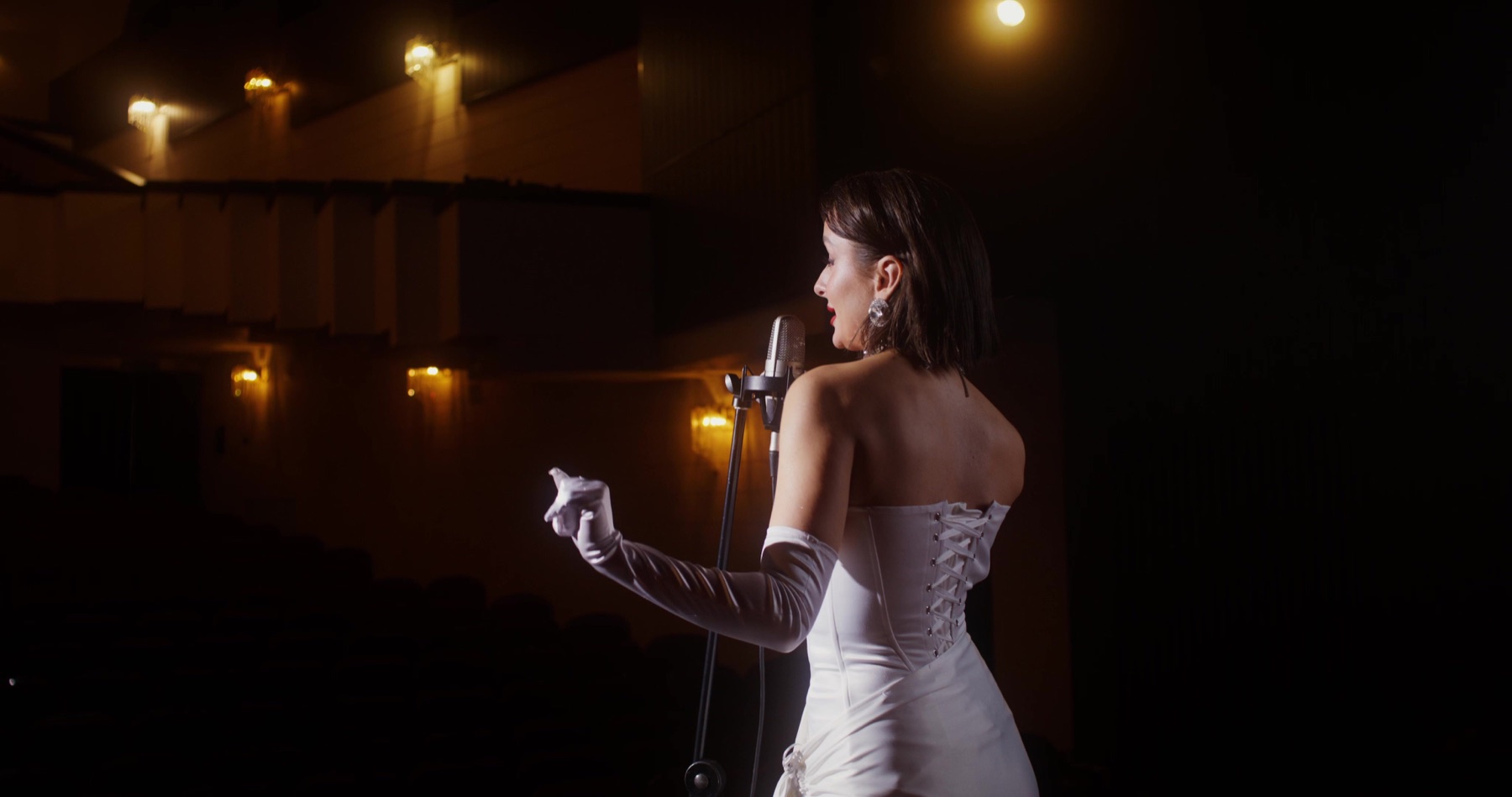 Singer performing on a theatre stage